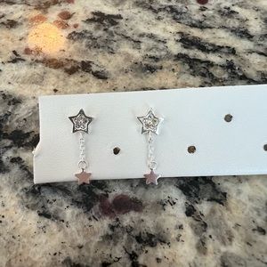 Brand never silver star drop earrings. Perfect condition no flaws!